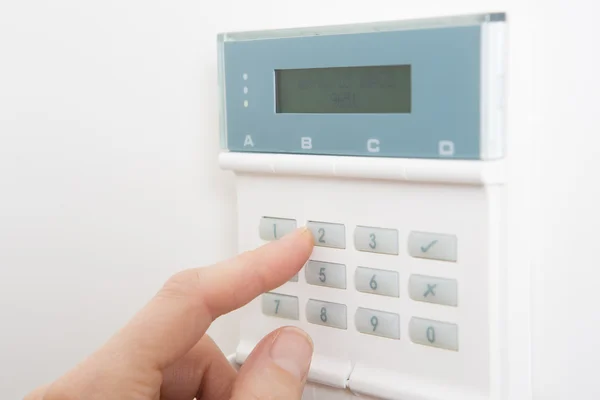 Woman Setting Control Panel On Home Security System — Stock Photo, Image