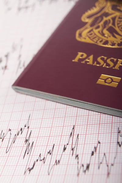 UK Passport On ECG Printout To Illustrate Risk Of Catching Illne — Stock Photo, Image