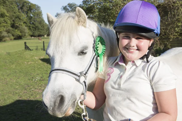 Girl With Prize Winning Pony In Field