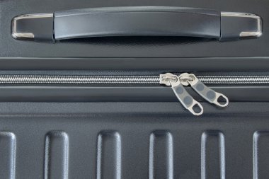 Top view of silver zipper of hard shelled suitcase, new and clean luggage in black clipart