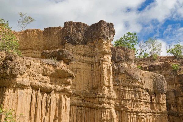 Natural phenomenon of eroded cliff, soil pillars, rock sculptured by water — Stock Photo, Image