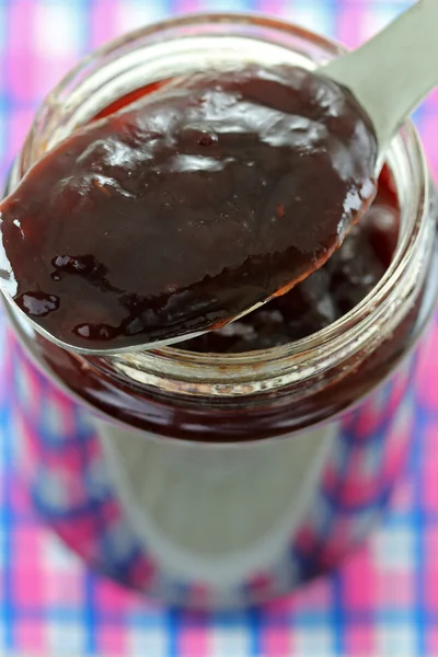 A jar of Raspberry jam with thyme Stock Photo