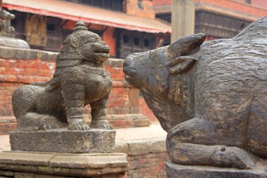Statue of cow and snow lion at Patan Darbar Square in Patan, Nepal clipart