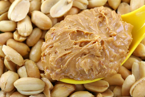 Peanut butter on roasted nuts — Stock Photo, Image