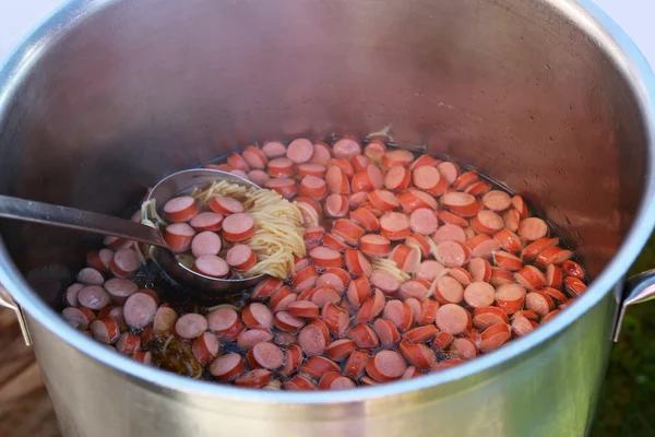 A pot of Noodle soup with sausage — Stock Photo, Image