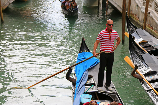 A Gondolier on Venetian canals in Venice, Italy