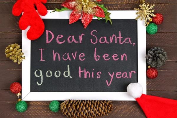 A white framed blackboard with a message to Santa Claus with — Stock Photo, Image