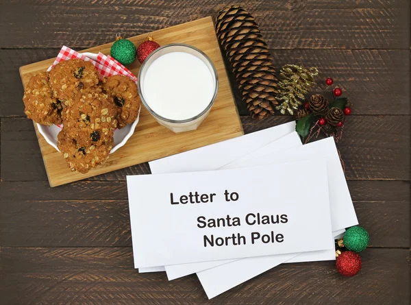 Homemade cookie next to a glass of milk and letters to Santa Claus — Stock Photo, Image