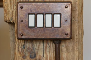 Bakelite toggle light switch in brown on wooden pole  clipart
