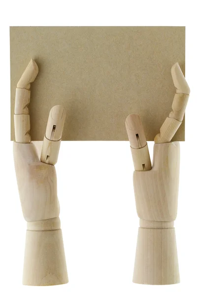 Mani di legno con in mano un pezzo di carta bianca marrone — Foto Stock