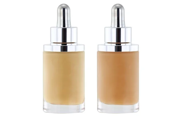 Bottles of liquid foundation with dropper in pink and yellow und — Stock Photo, Image