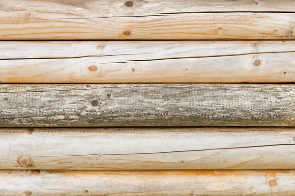 Textura de fondo de primer plano de una pared hecha de troncos de madera brillante —  Fotos de Stock