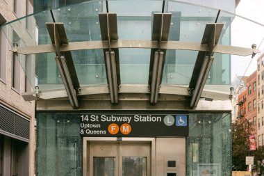 New York 'taki 14. sokak metro istasyonuna giriş modern mimariyi ve şehir hayatını yansıtıyor..