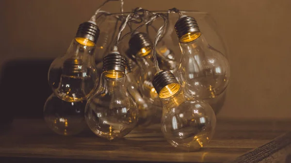 Electric garlands in the form of a light bulb shine in the dark