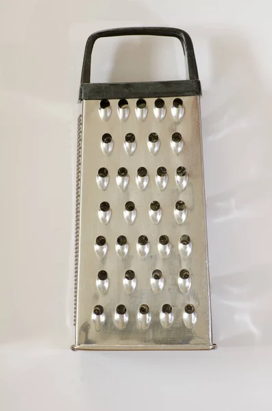 Stainless steel box grater with handle well used for grating cheese and vegetables in kitchen