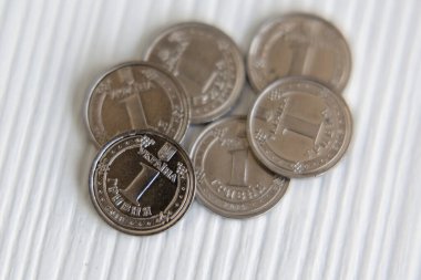 Ukrainian currency hryvnia coins on a white background. Ukrainian money. Inflation, business, economics and finance theme.