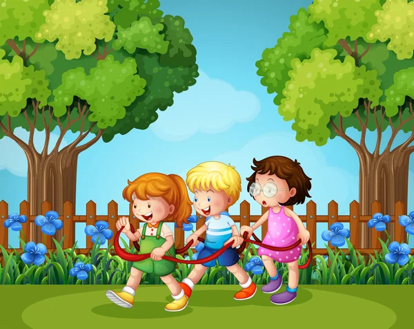 Tres niños jugando en el jardín — Vector de stock