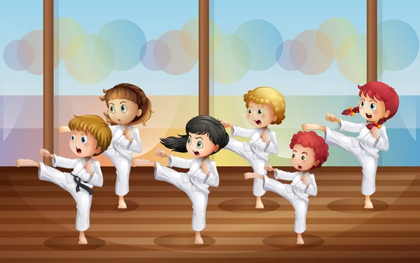 Niños practicando karate — Vector de stock