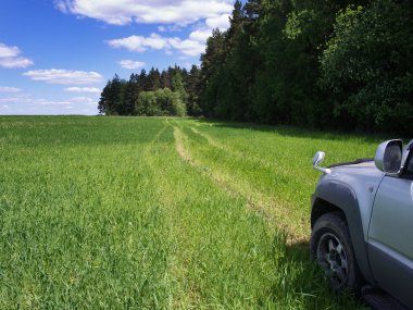 Car on road through field