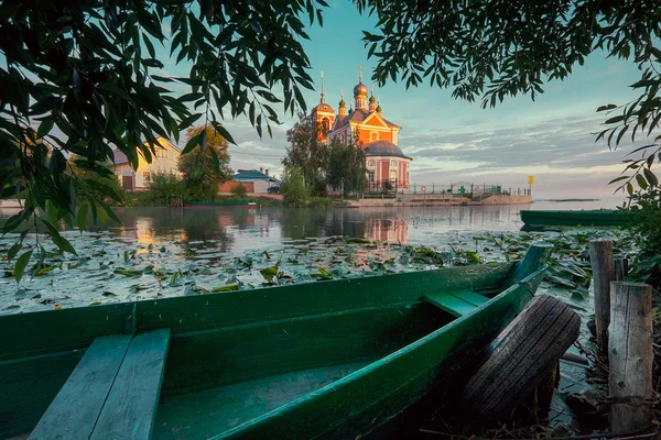Wooden boat and church — Stok fotoğraf