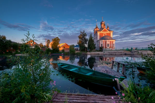 Wooden boat and church — Stok fotoğraf