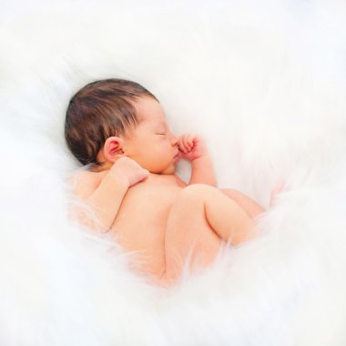 Newborn baby sleeping on the white  clipart