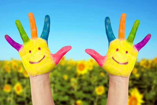 Two smiley hands in sunny summer's day. — Stock Photo, Image