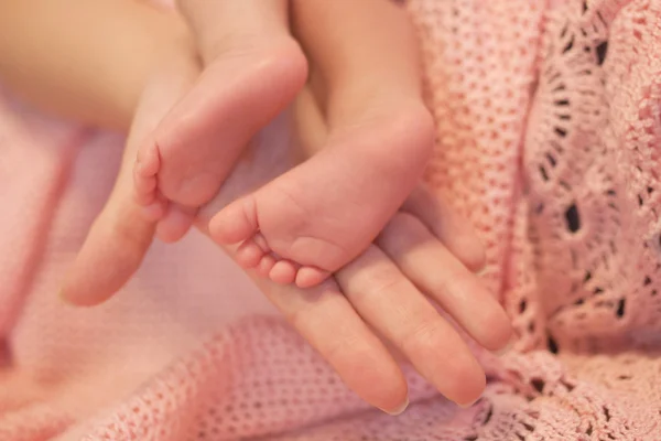 Matki ręka trzymać stopy dziecka — Zdjęcie stockowe