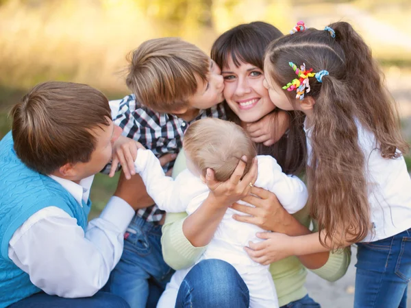 Large family hugging and having fun outdoors. — Stock Photo, Image