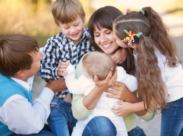 Large family hugging and having fun outdoors — Stock Photo, Image