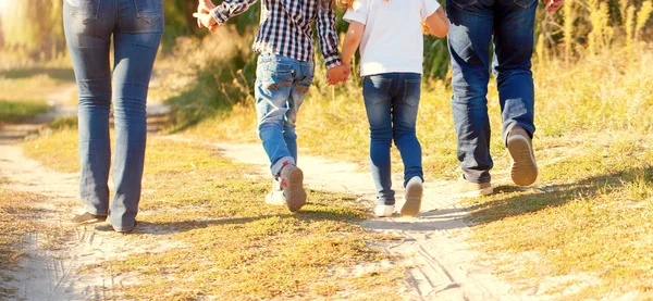 Family feet walking on the path. Rear view. — Stock Photo, Image