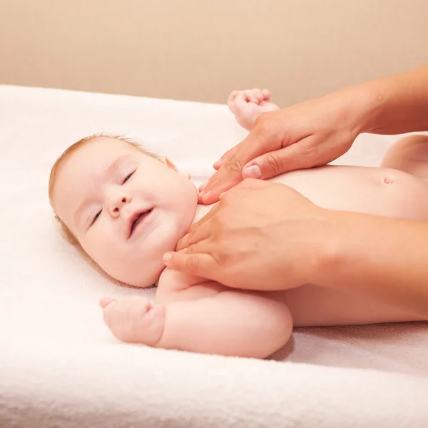 Mother massaging baby neck — Stock Photo, Image