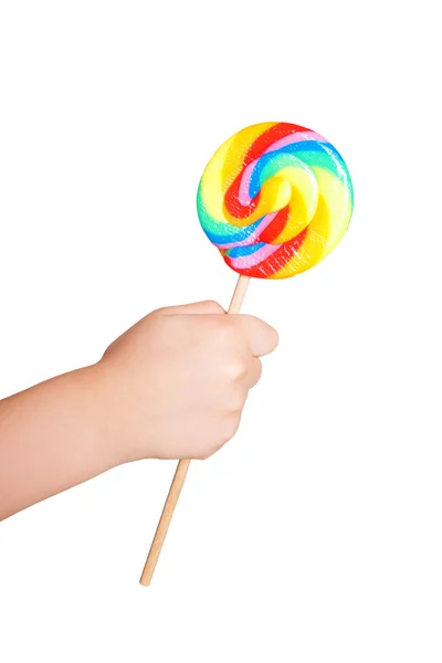 Child's hand holding lollipop candy — Stock Photo, Image
