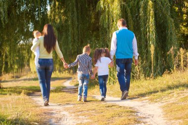 Big family walking in city park. clipart