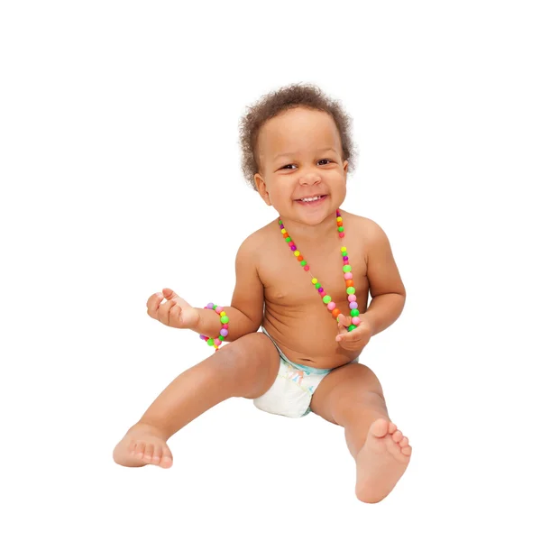 Laughing mulatto black baby wearing a beads — Stock Photo, Image