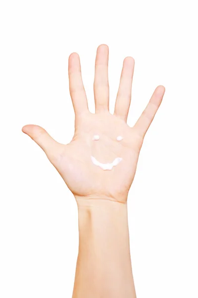 Sonrisa pintada crema de manos en la palma — Foto de Stock