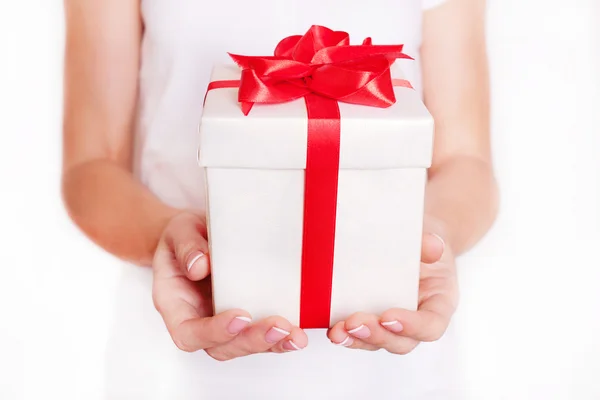 Woman holding a gift box. Time gifts. Stock Photo