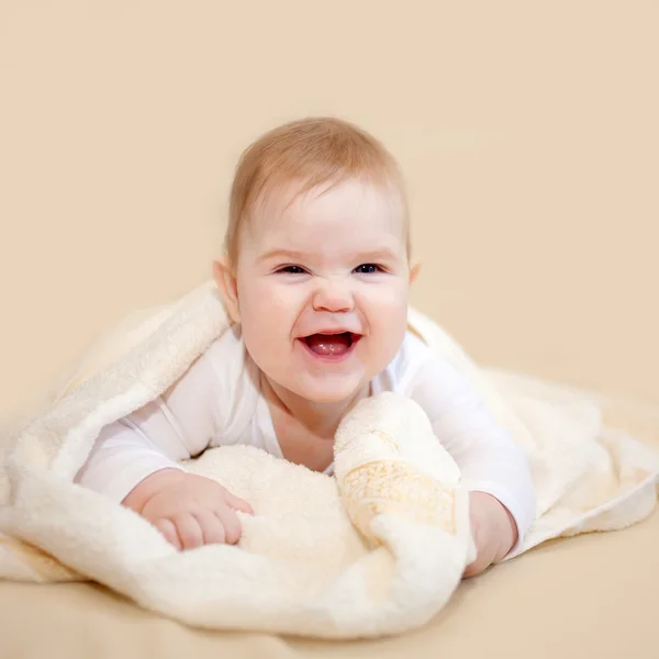 Laughing baby wrapped in towel after bath — Stock Photo, Image