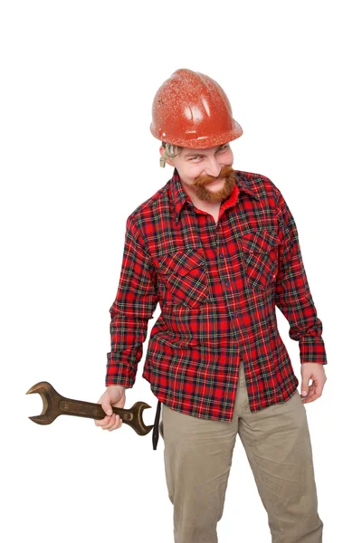 Hombre sonriente en casco con llave inglesa . — Foto de Stock