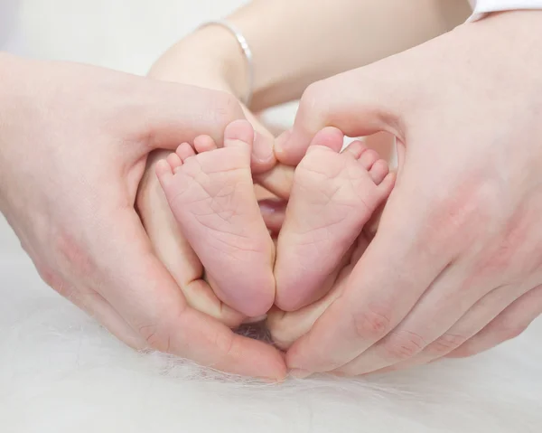 Vater und Mutter halten Füße von Neugeborenen — Stockfoto