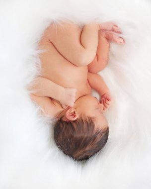Newborn baby sleeps upside down. clipart