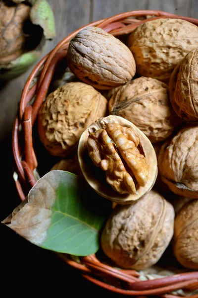 Walnut in basket on rustic old wood — Stock Photo, Image