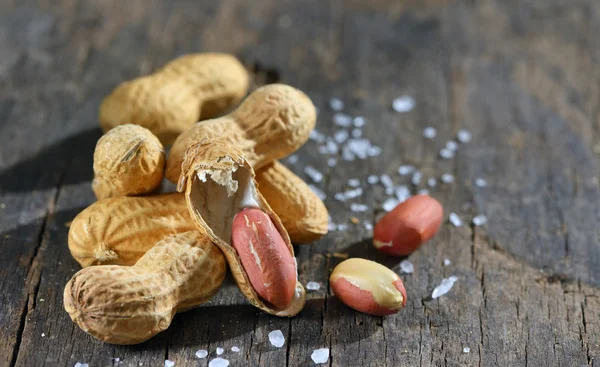 Peanut isolated on wooden background — Stock Photo, Image