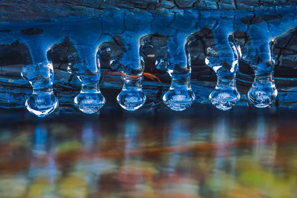 Background of bright blue transparent icicles in the sunlight — Stock Photo, Image