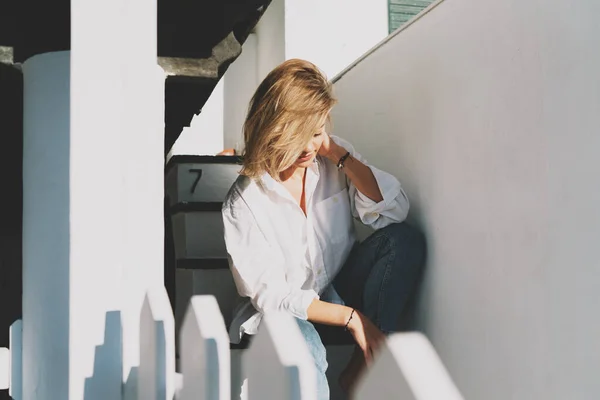 Mooie Blonde Vrouw Met Wit Shirt Blauwe Jeans Die Neerkijkt — Stockfoto