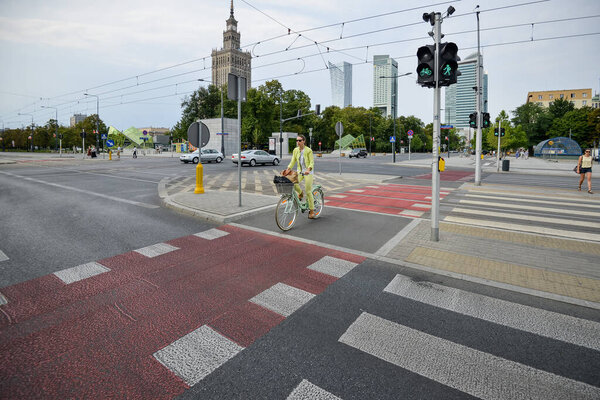 WARSAW. POLAND - August 2015: A pedestrian crossing button in the center of Warsaw with the word CAUTION. Against the background of a summer green park.