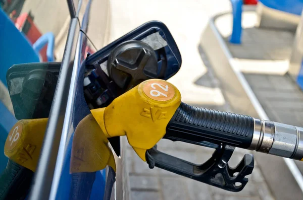 MINSK. BELARUS: 13.06.2013 - Gasolinera. La pistola de reabastecimiento está en la solapa de llenado de combustible de los coches azules. — Foto de Stock