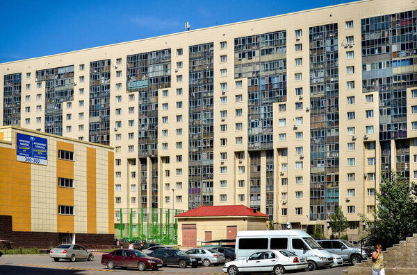 Nur-Sultan. Kazakhstan: 04.09.2013 - Yellow residential buildings, a residential complex against a blue sky. Nur-Sultan.