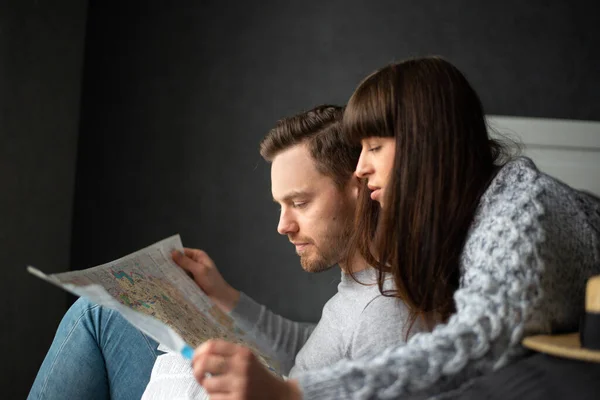 Couple in love man and woman choose place on paper map for travel — Stock Photo, Image