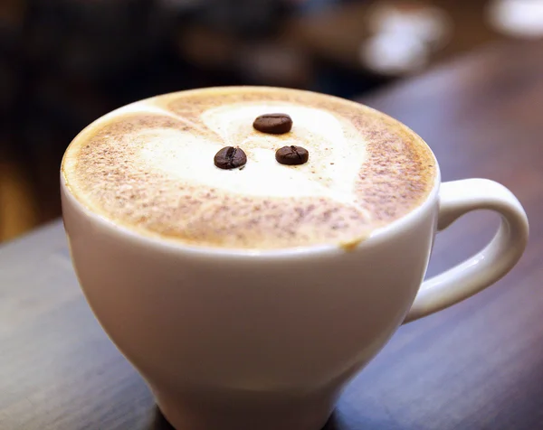 White cup of coffee with beans — Stock Photo, Image